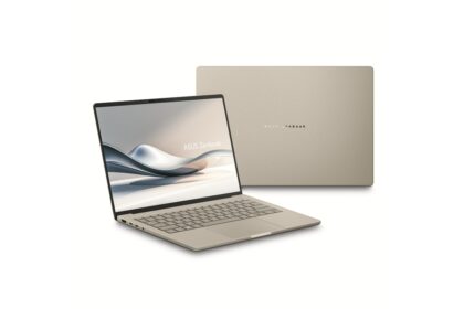 Beige ASUS Zenbook laptop open, screen showing abstract wave design with the lid closed behind it.