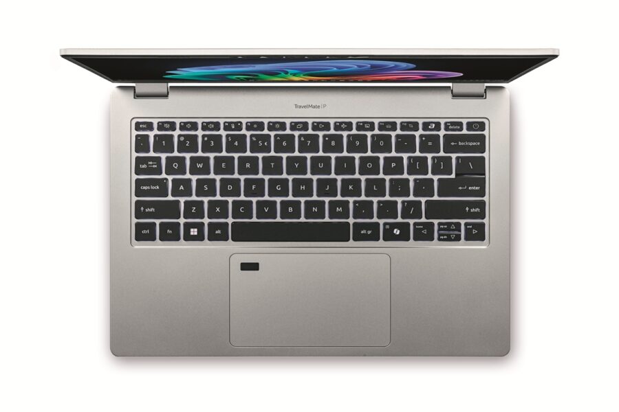 Top-down view of a silver laptop open to reveal a black keyboard and colorful screen wallpaper on a white background.