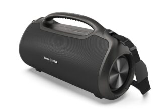 Black portable Bluetooth speaker with a top handle, cylindrical body, and fabric grille; strap attached on the side.
