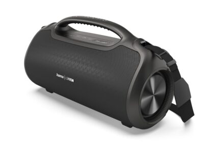 Black portable Bluetooth speaker with a top handle, cylindrical body, and fabric grille; strap attached on the side.