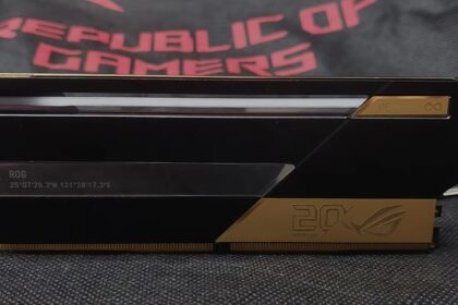 Close-up of a black ROG graphics card with a thin horizontal vent and gold accents.