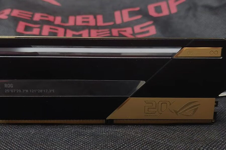 Close-up of a black ROG graphics card with a thin horizontal vent and gold accents.
