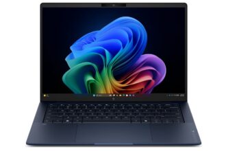 Front view of an open dark blue laptop displaying a colorful abstract wallpaper on the screen, keyboard visible.