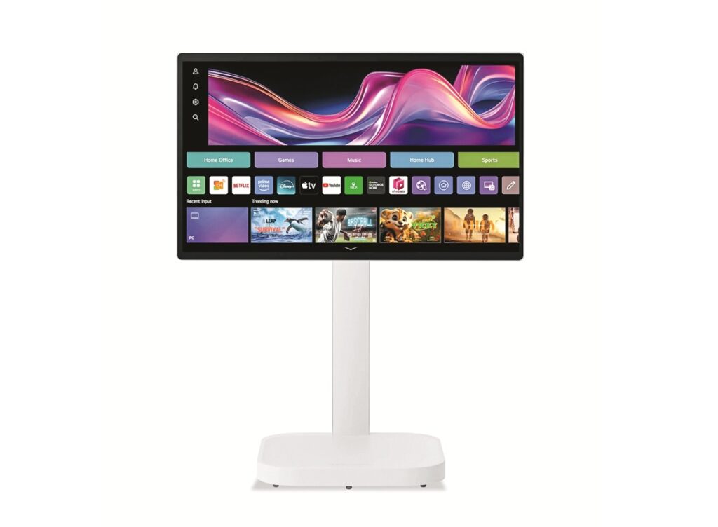 Widescreen monitor on a white stand showing a colorful home-screen interface with app tiles and icons.
