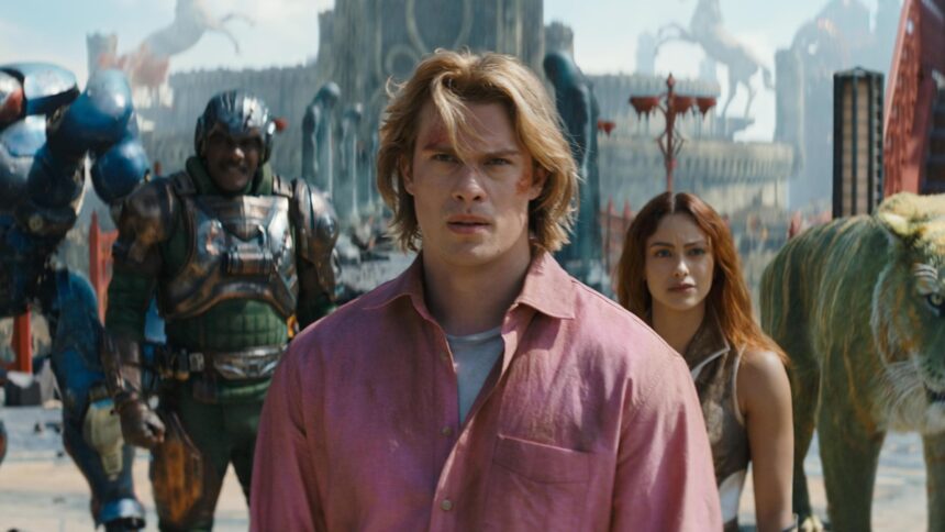 Young man in a pink shirt at center, with a woman behind him, amid armored soldiers and a large creature in a futuristic battlefield.