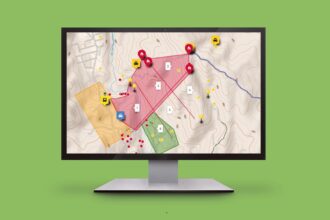 Monitor displaying a topographic map with colored zones, numbered plots, and warning icons for incidents on screen.