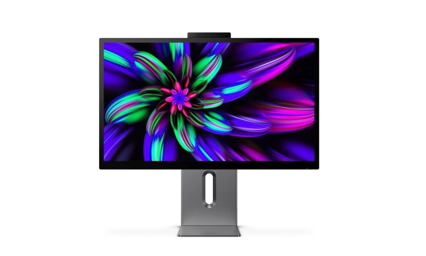 Slim computer monitor on a metal stand displaying a vibrant abstract wallpaper with neon greens, purples, and pinks. Center cutout in the stand is visible.