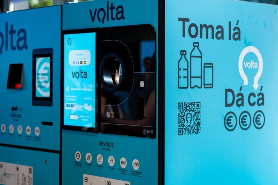 Public bottle-return kiosk with blue Volta branding, touch screen, and a QR code