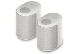 Pair of white cylindrical wireless speakers with mesh fronts, shown at an angle on a white background.