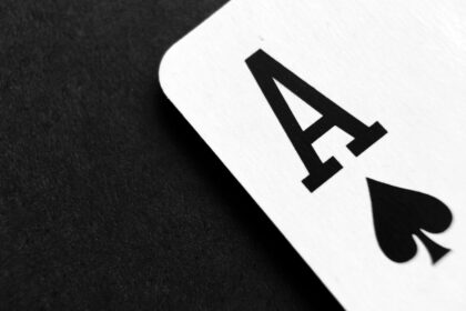Close-up of a white card showing a bold black 'A' on a dark surface.
