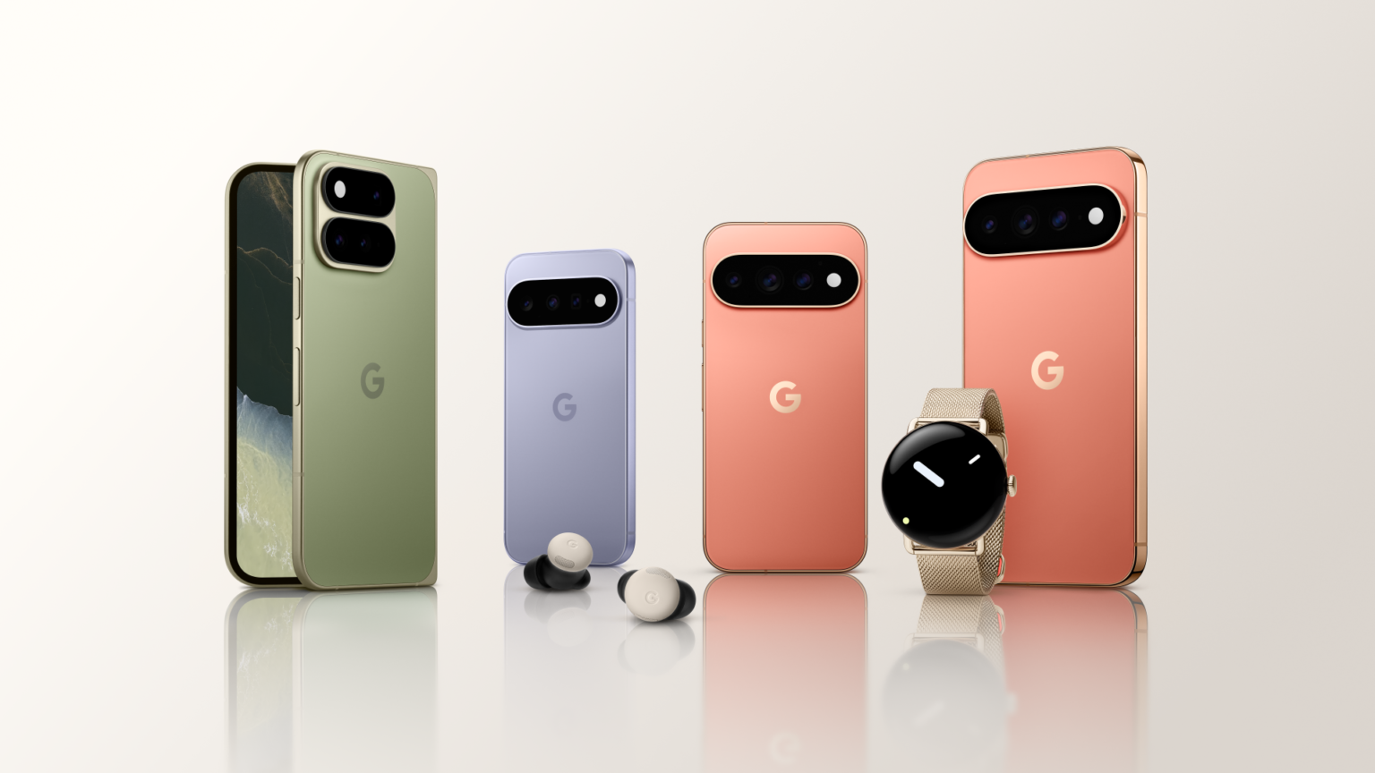 Lineup of Google Pixel smartphones in green, lilac, peach, and pink-gold colors on a reflective surface.