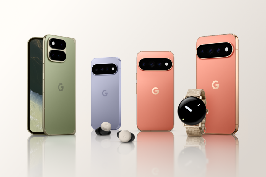 Lineup of Google Pixel smartphones in green, lilac, peach, and pink-gold colors on a reflective surface.