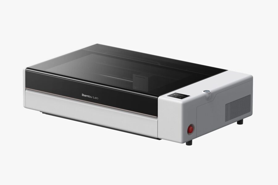 Desktop 3D printer with a black front panel and transparent lid, brand 'Bambu Lab' visible on the front edge.