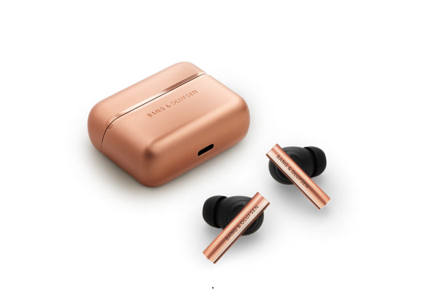 Rose-gold wireless earbuds with a matching rose-gold charging case; brand Bang & Olufsen visible on both pieces.