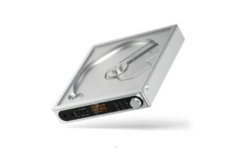 Portable silver turntable with a clear lid, black control panel, and orange display on the front.
