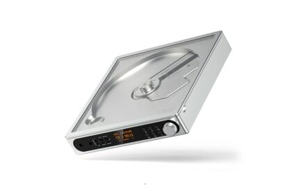 Portable silver turntable with a clear lid, black control panel, and orange display on the front.