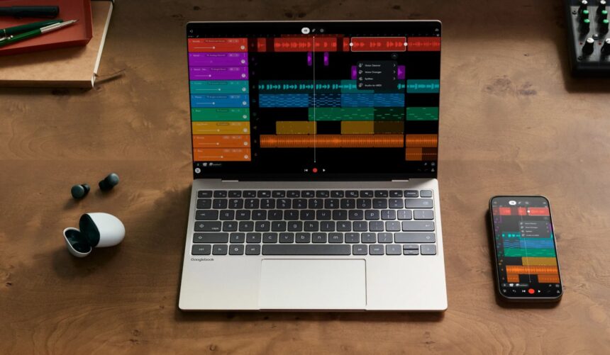 Laptop shows a colorful digital audio workstation with a track timeline on a wooden desk, with a smartphone displaying the same app nearby.