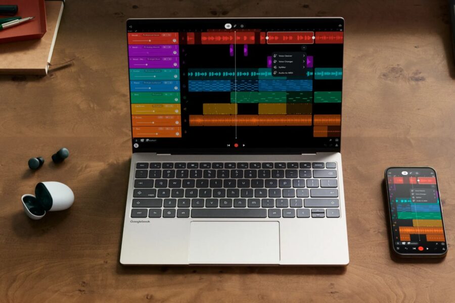 Laptop shows a colorful digital audio workstation with a track timeline on a wooden desk, with a smartphone displaying the same app nearby.