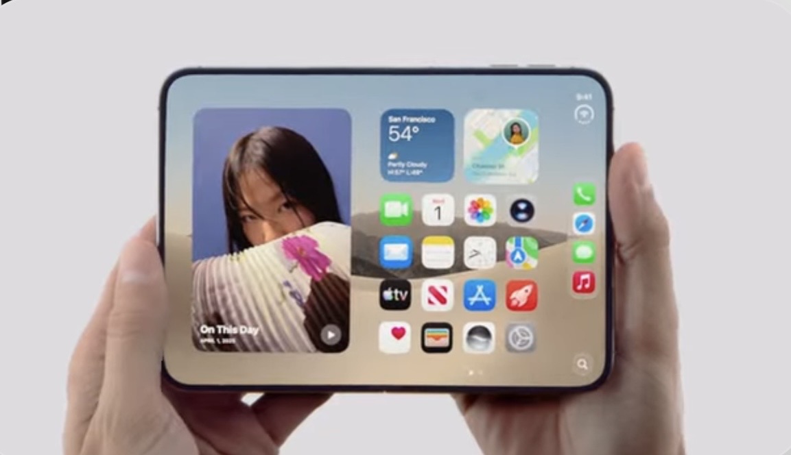 Hands hold a smartphone showing a wide home screen with colorful app icons and widgets.