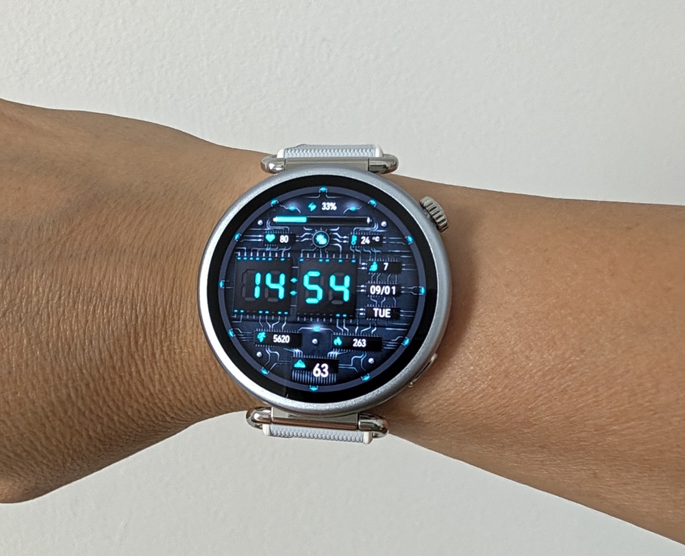 Smartwatch on a wrist with a blue digital face showing time 14:54 and date 09/01 Tue.