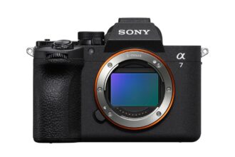 Front view of a Sony Alpha 7 mirrorless camera body with exposed E-mount and orange ring, black textured grip on the left.
