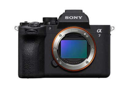 Front view of a Sony Alpha 7 mirrorless camera body with exposed E-mount and orange ring, black textured grip on the left.