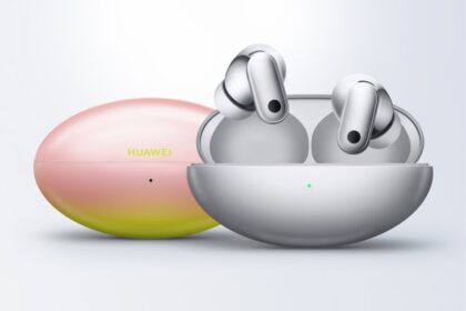 Huawei true wireless earbuds in an open charging case with a gradient pink-yellow protective case beside them, brand visible on the lid.