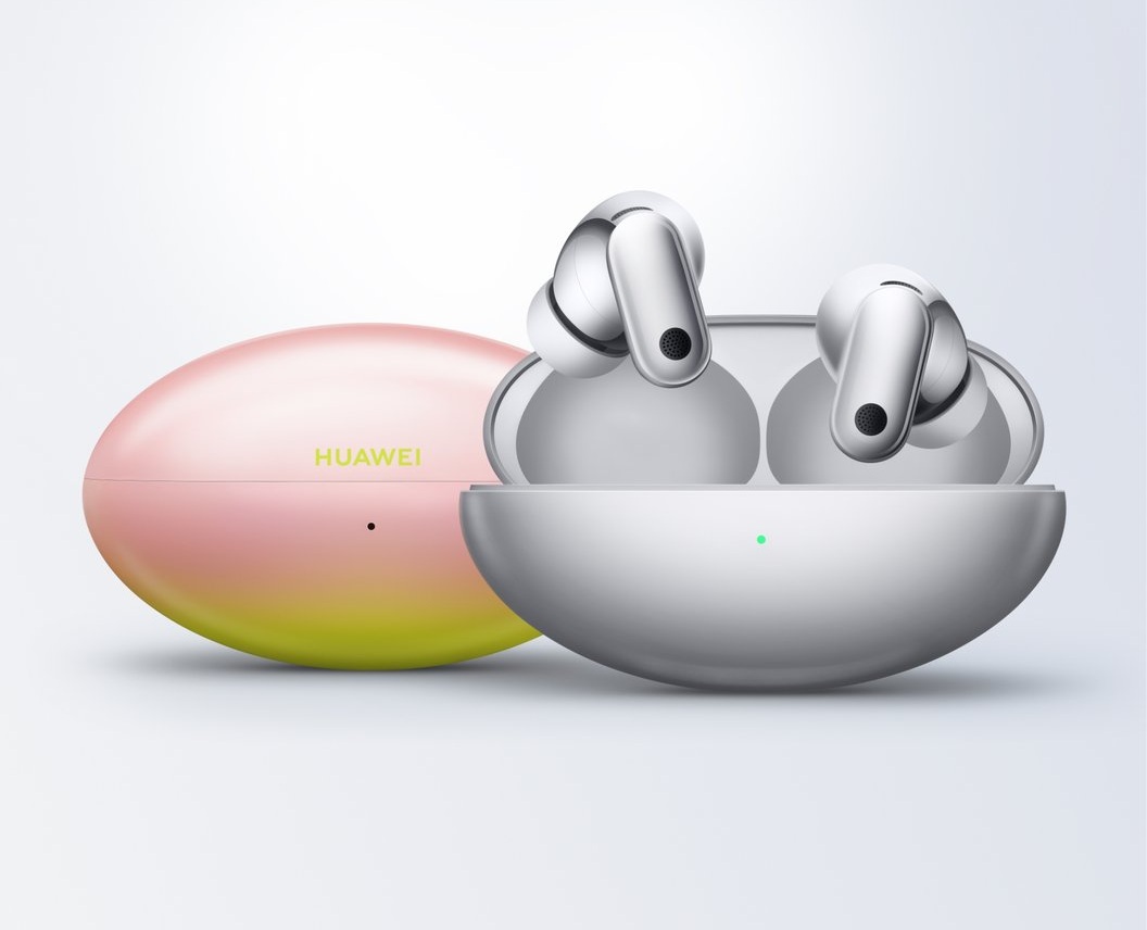 Huawei true wireless earbuds in an open charging case with a gradient pink-yellow protective case beside them, brand visible on the lid.