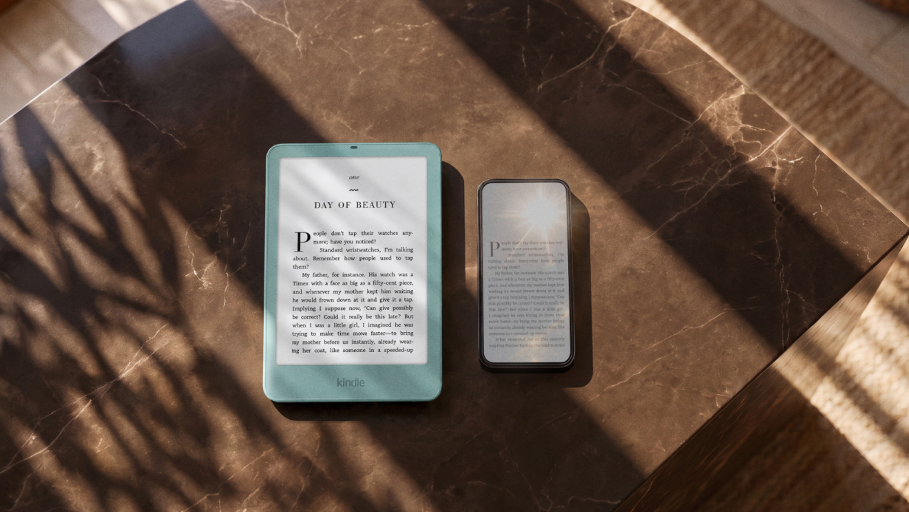 Two e-readers (one teal Kindle, one darker device) sit on a brown marble table with dramatic shadows and sunlight.
